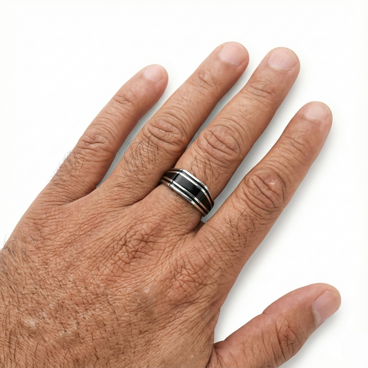 Hand wearing a silver ring on a white background