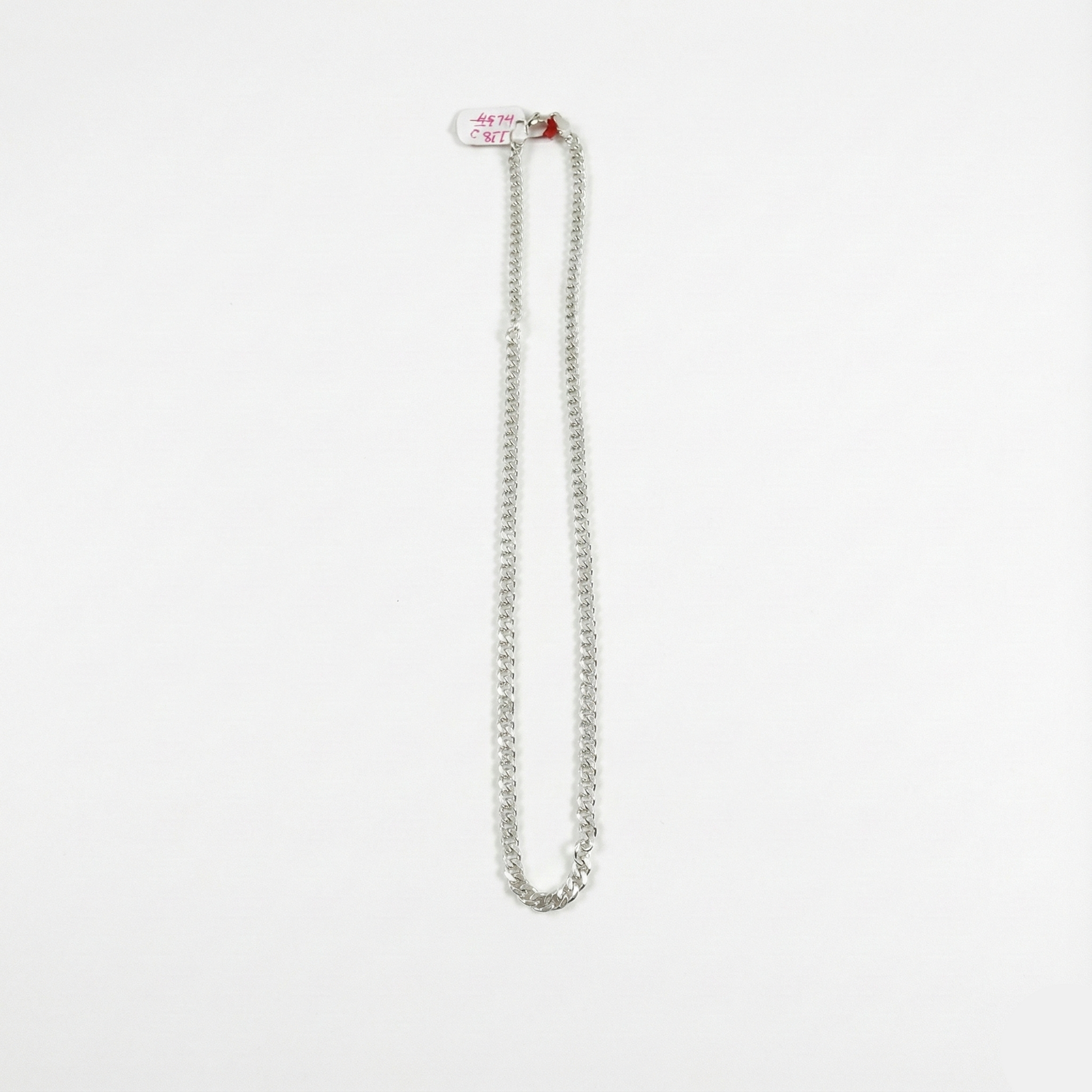 Silver chain necklace on a white background