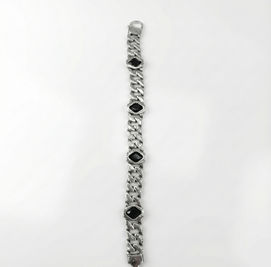Silver bracelet with black gemstones on a white background