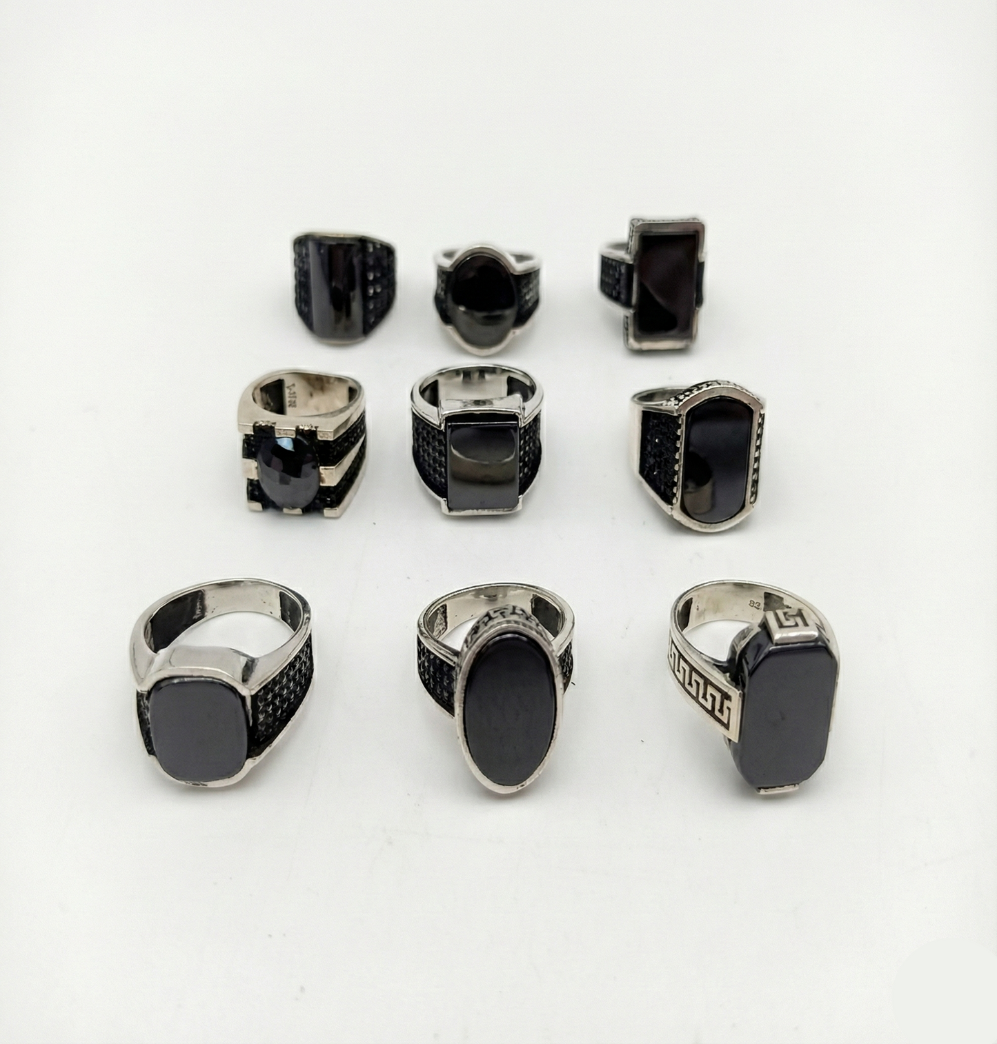 Collection of black and silver rings on a white background