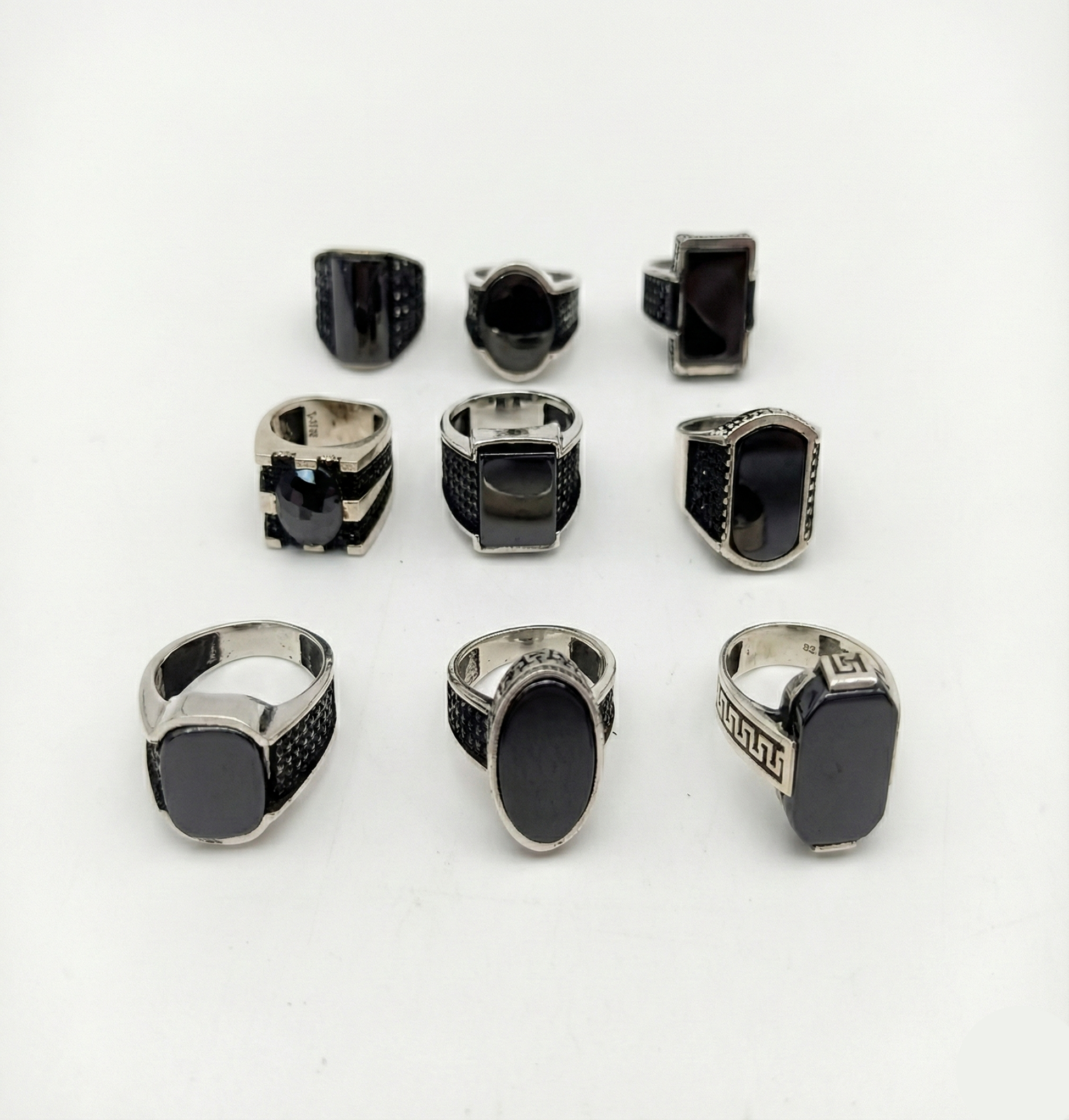 Collection of black and silver rings on a white background