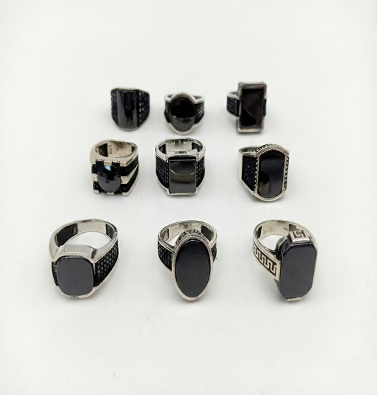 Collection of black and silver rings on a white background
