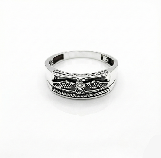 Silver ring with wing design on a white background