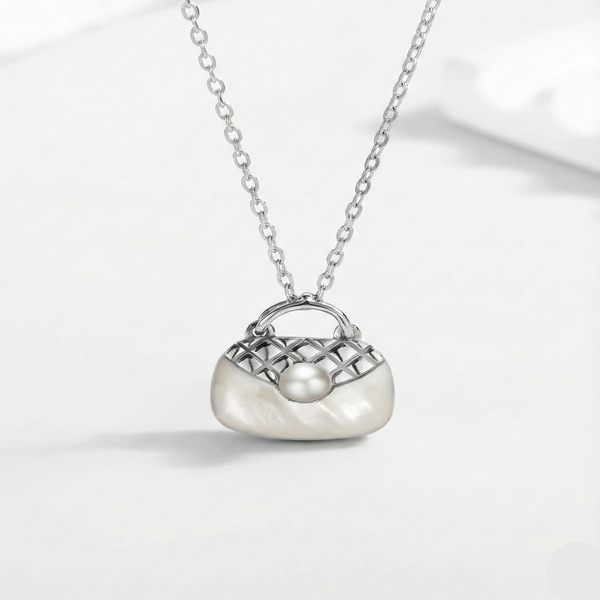 Silver necklace with a handbag-shaped pendant on a white background