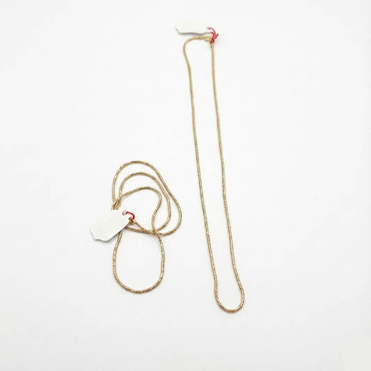 Gold chain necklace on a white background