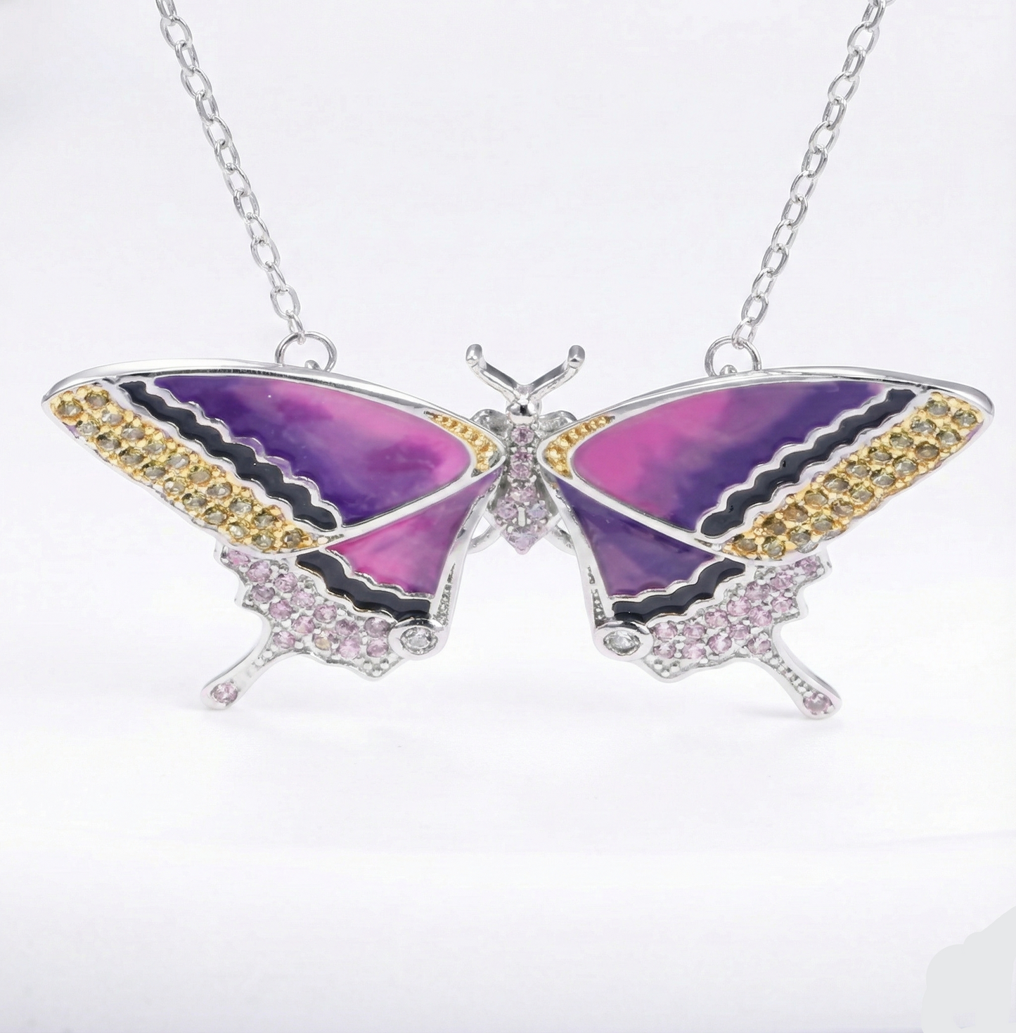 Butterfly-shaped necklace with purple wings and gold accents on a white background