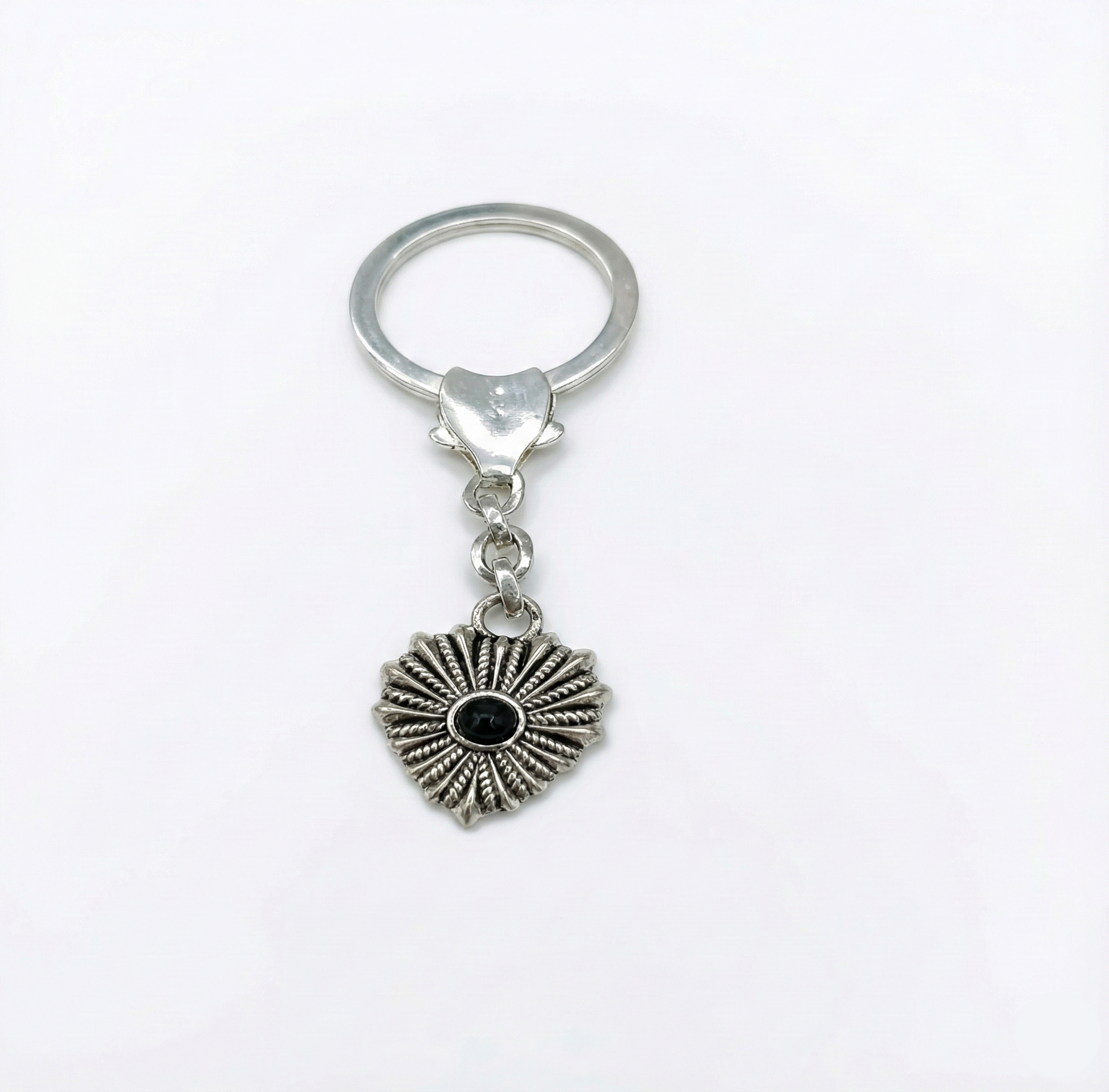 Silver keychain with a heart-shaped pendant on a white background