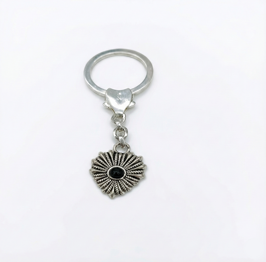 Silver keychain with a heart-shaped pendant on a white background