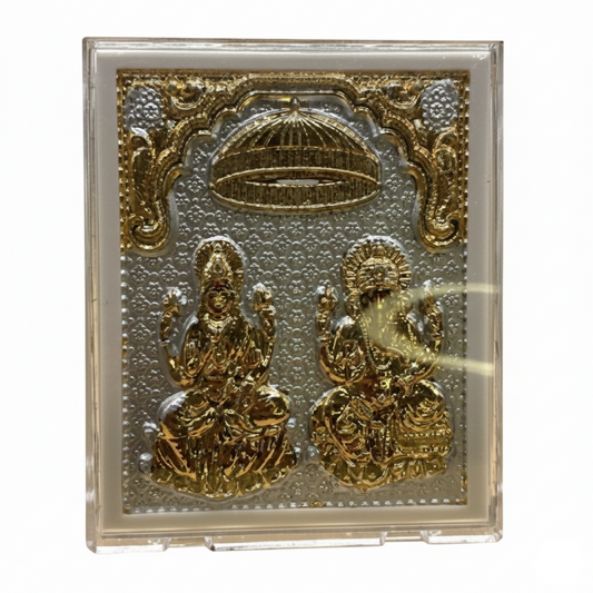 Decorative plaque with gold figures and intricate designs on a white background