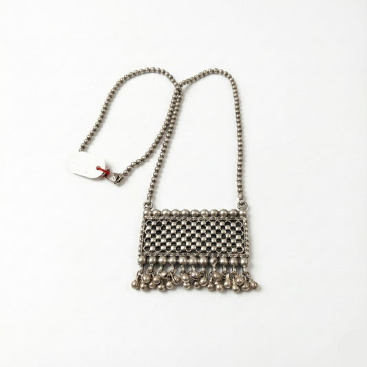 Small metallic handbag with chain strap on a white background