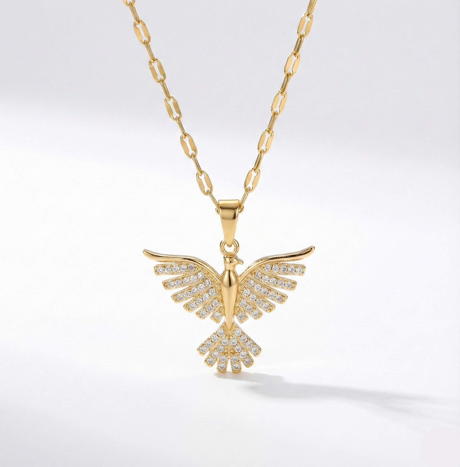 Gold necklace with a butterfly pendant on a white background