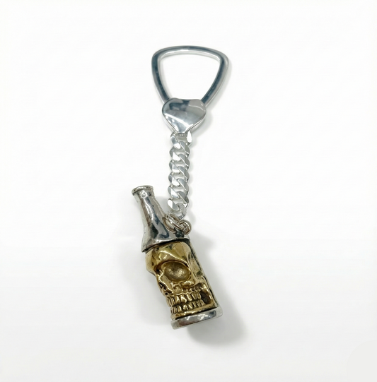 Bottle opener keychain with skull design on a white background