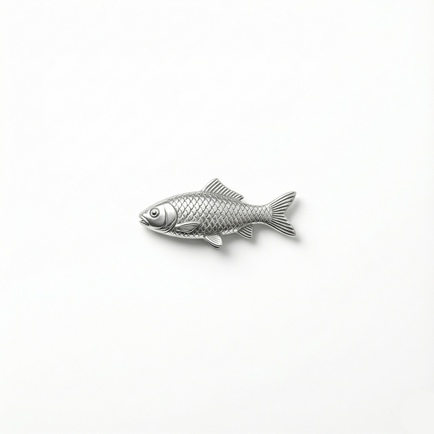 Silver fish-shaped pendant on a white background