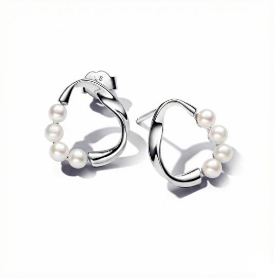 Silver hoop earrings with pearls on a white background