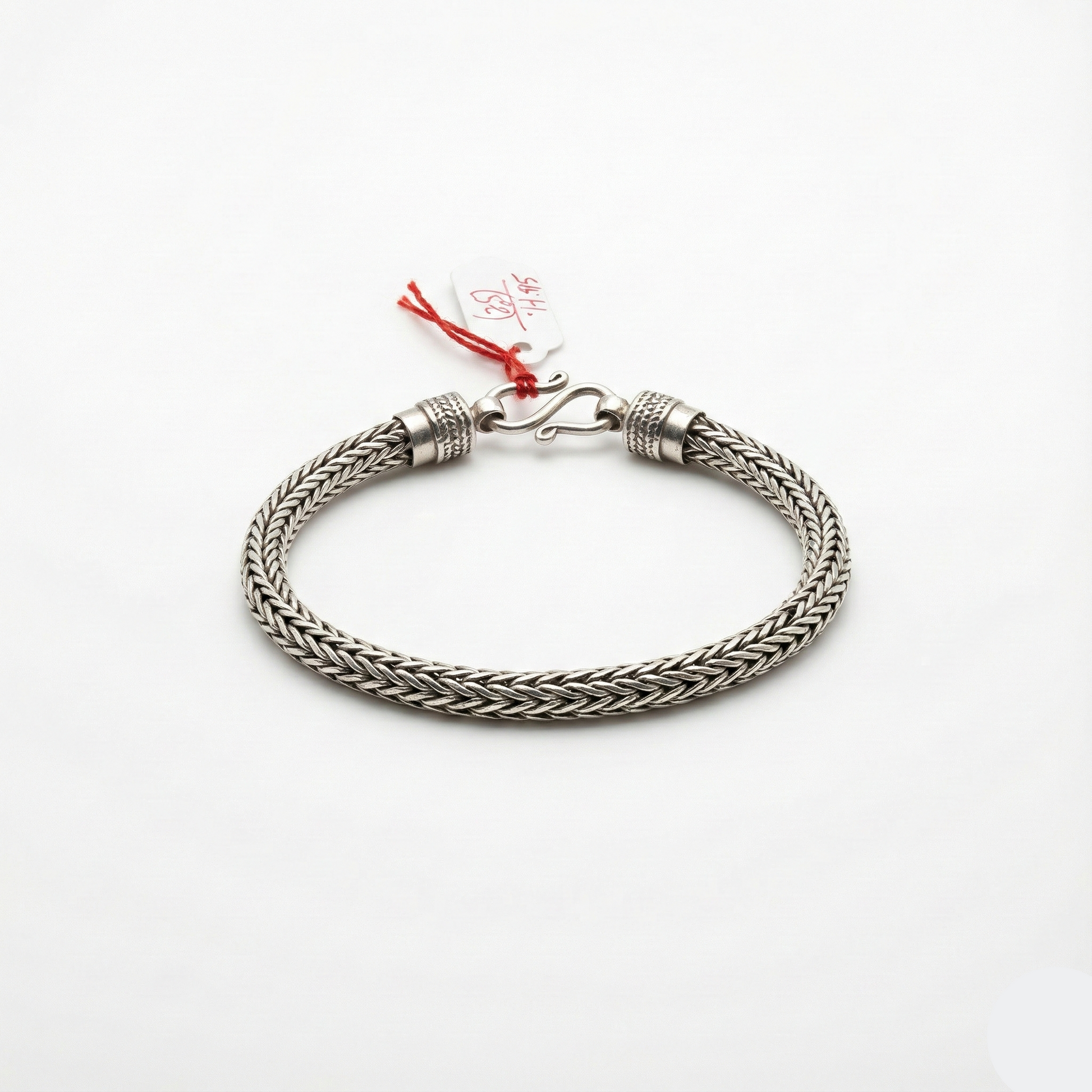 Silver braided bracelet on a white background
