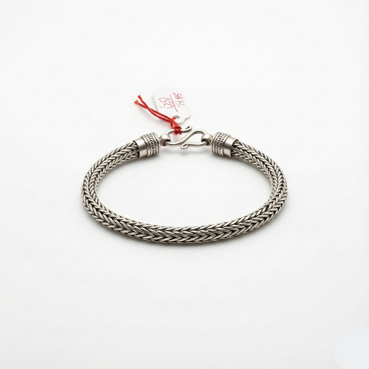 Silver braided bracelet on a white background