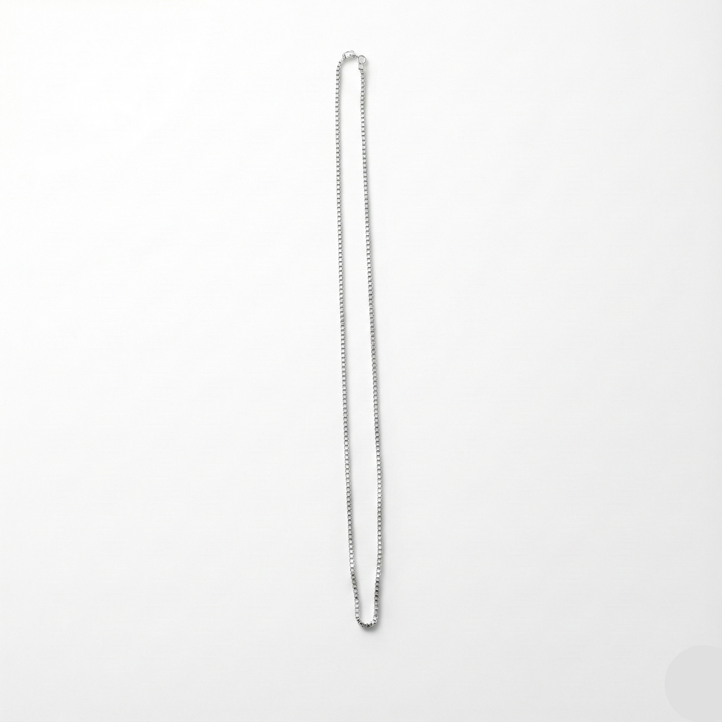 Silver chain necklace on a white background
