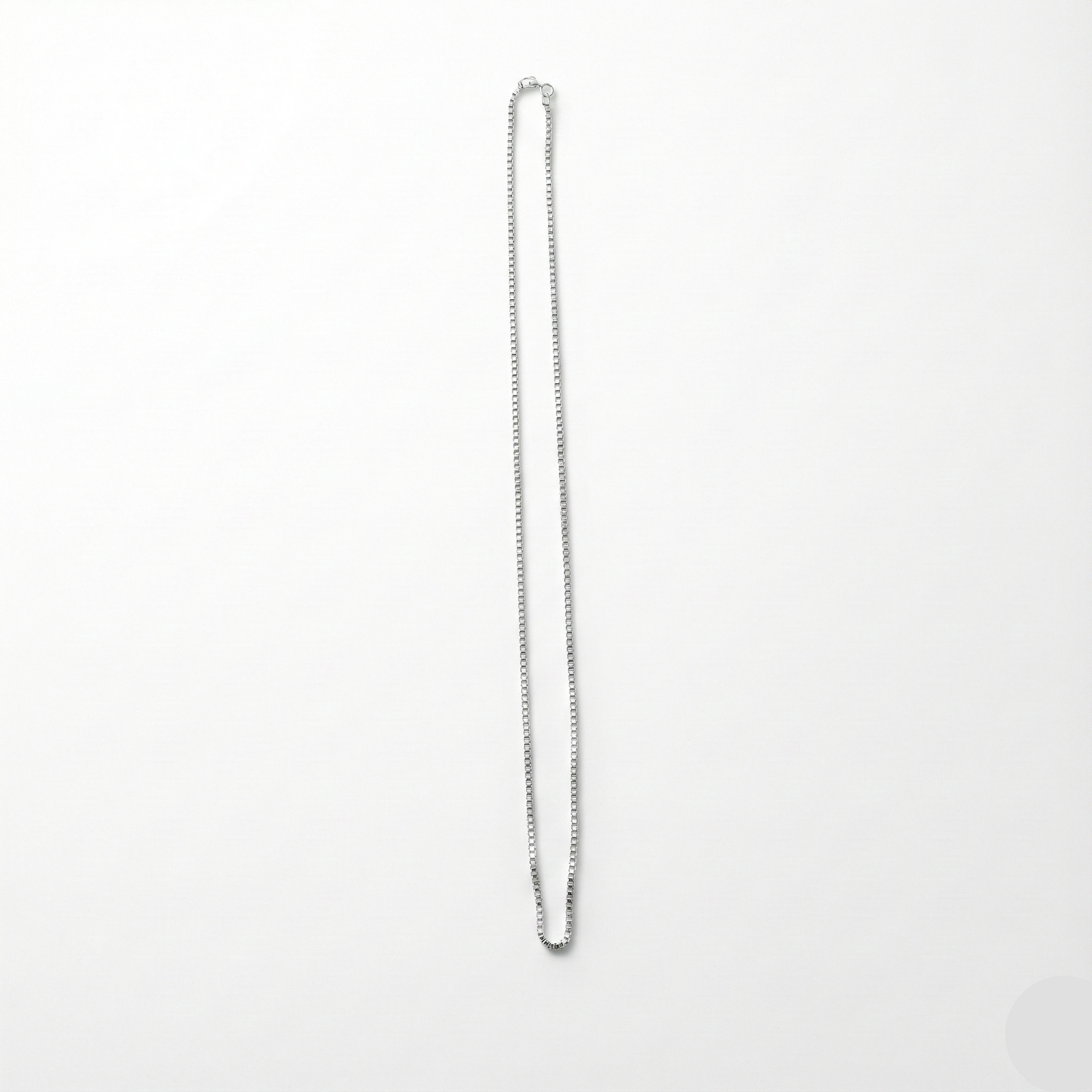 Silver chain necklace on a white background