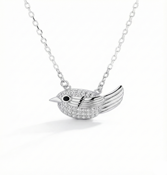 Silver bird-shaped pendant necklace on a white background