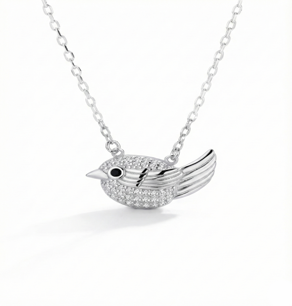 Silver bird-shaped pendant necklace on a white background