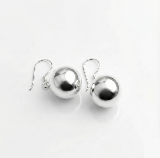Pair of silver sphere earrings on a white background