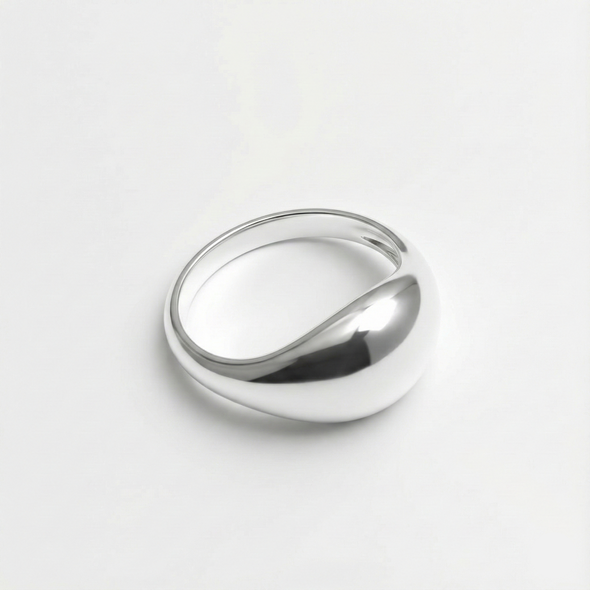 Silver ring on a light gray background