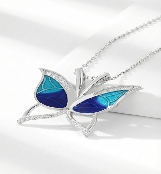 Butterfly-shaped pendant with blue wings on a white background
