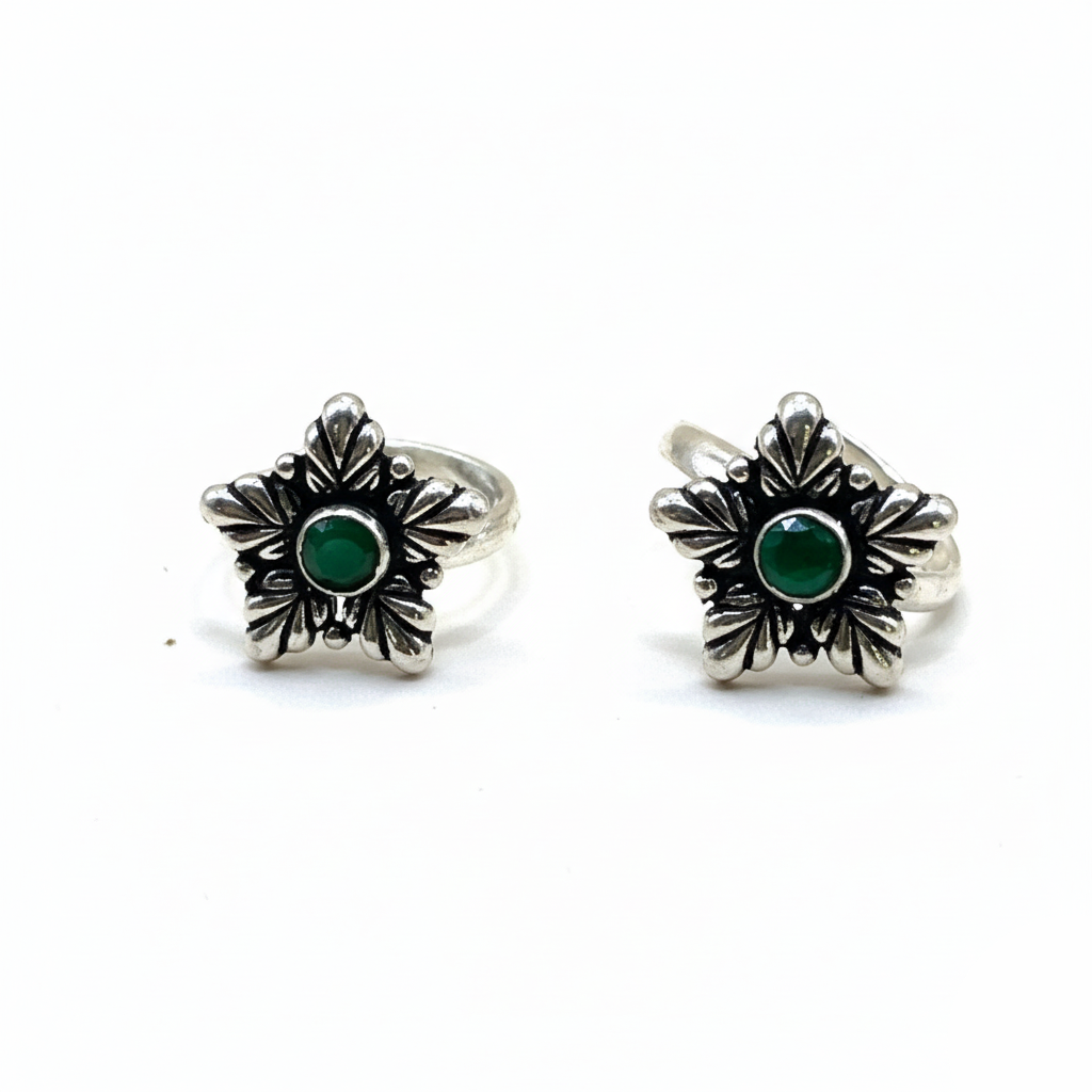 Pair of silver earrings with green gemstones on a white background