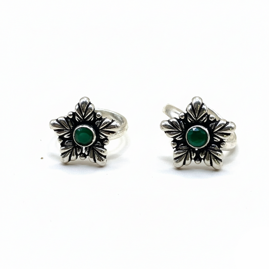 Pair of silver earrings with green gemstones on a white background