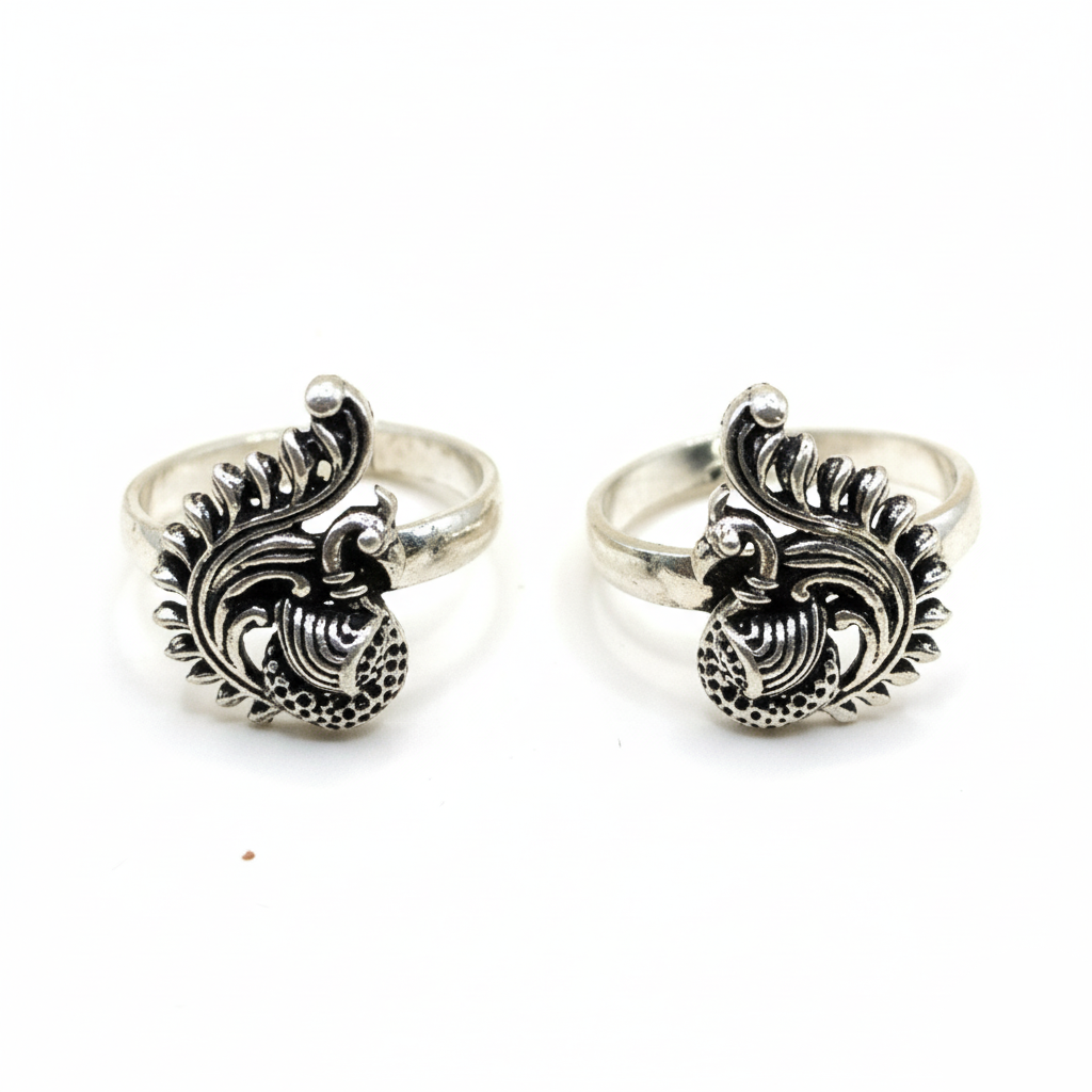 Pair of silver rings with intricate designs on a white background