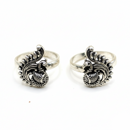 Pair of silver rings with intricate designs on a white background
