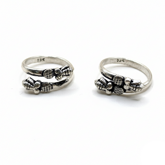 Two silver rings with bow designs on a white background