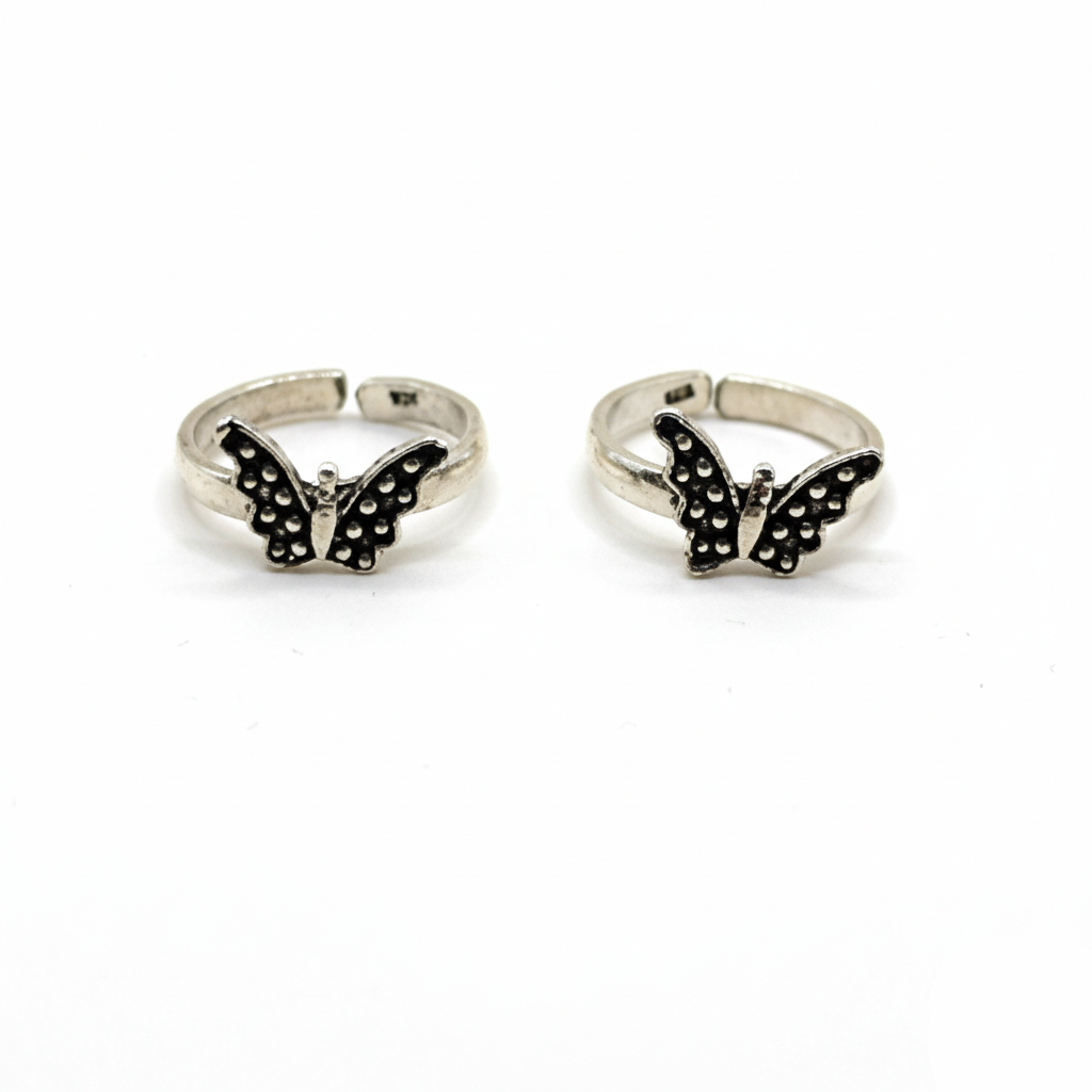 Butterfly-shaped silver rings on a white background