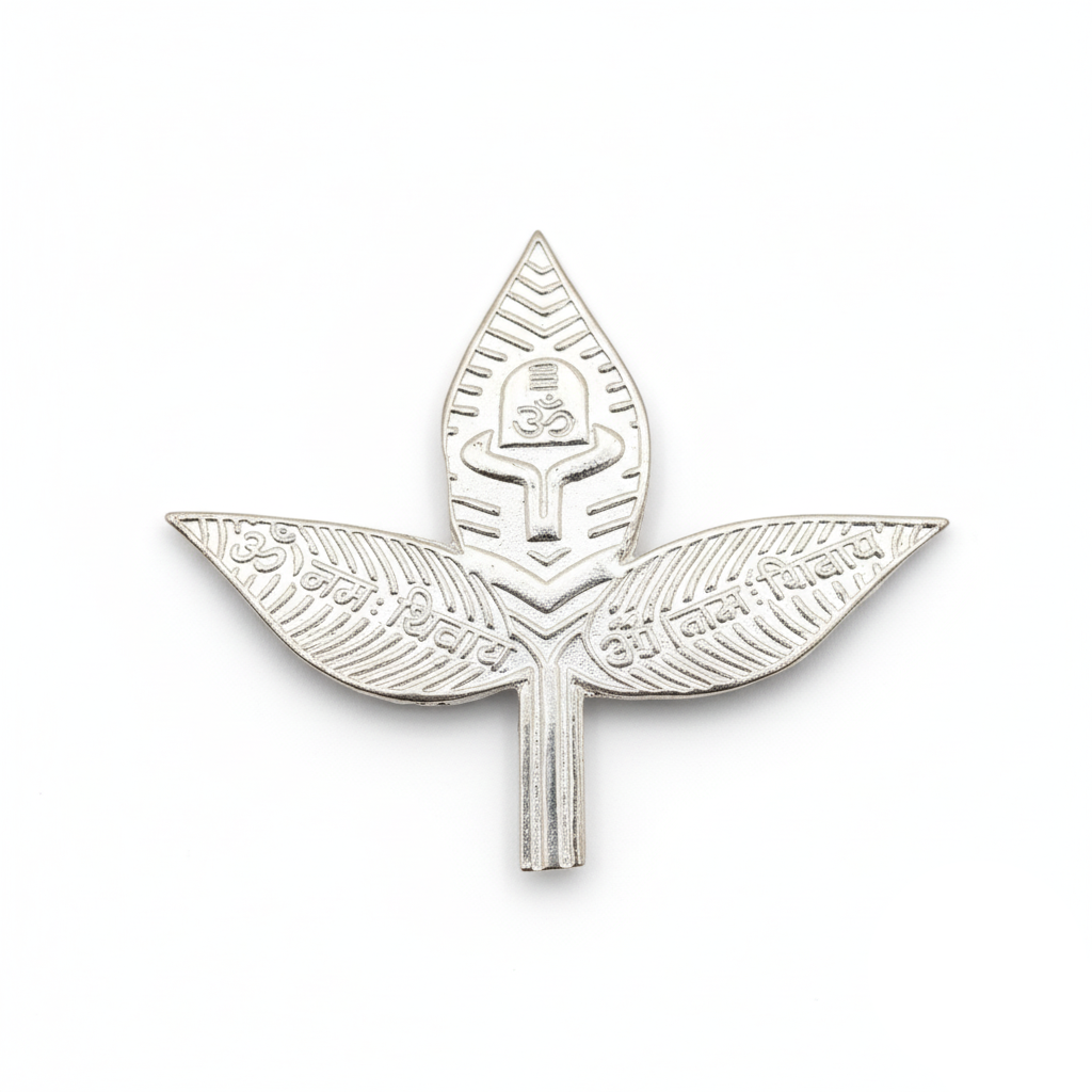 Silver leaf-shaped badge with intricate design on a white background