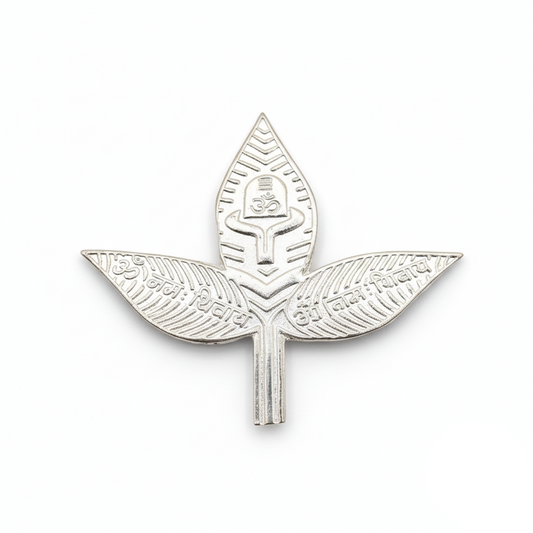 Silver leaf-shaped badge with intricate design on a white background