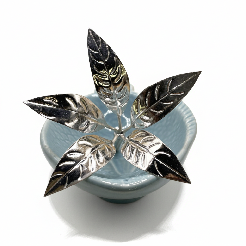 Decorative item with silver leaf design on a blue base