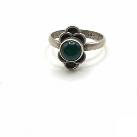 Silver ring with green gemstone on a white background