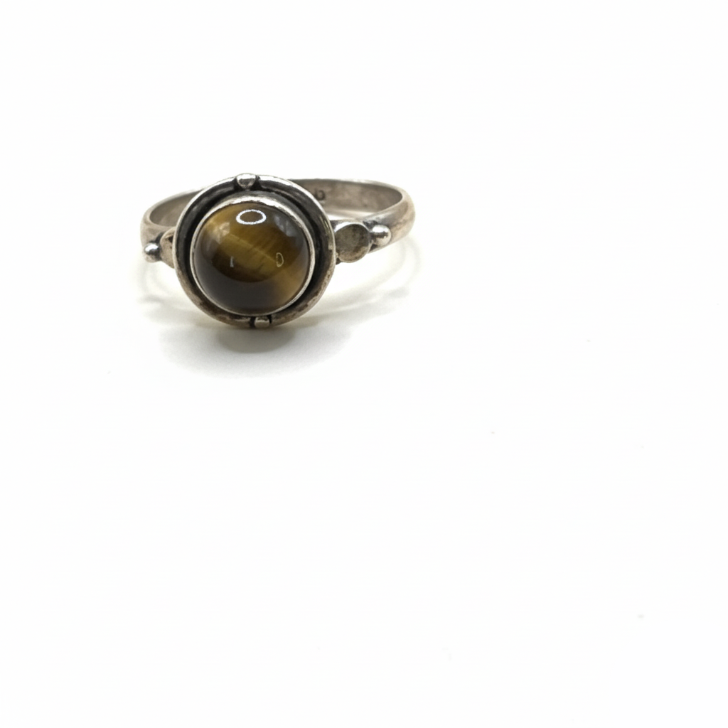 Silver ring with a tiger's eye stone on a white background