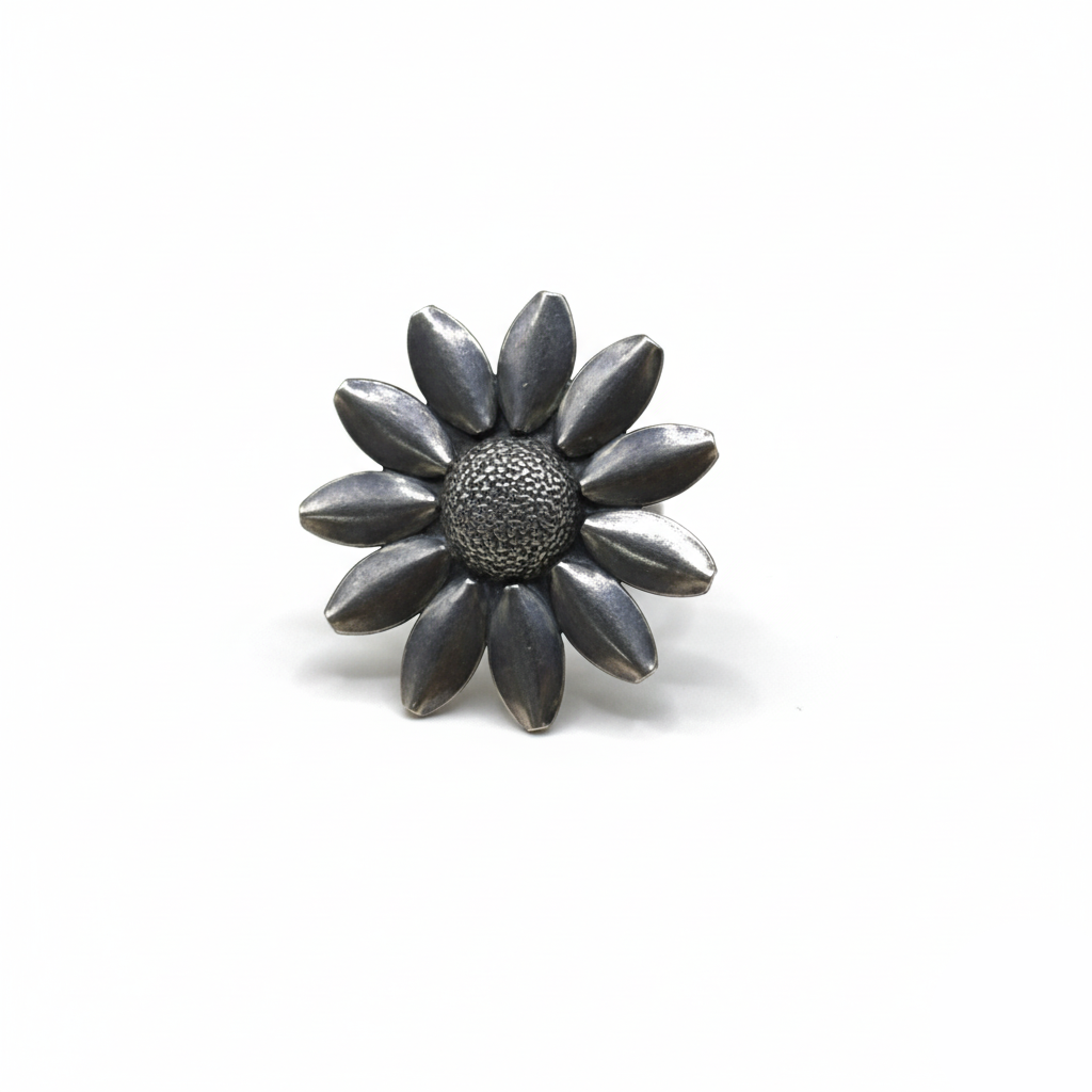 Silver flower-shaped brooch on a white background