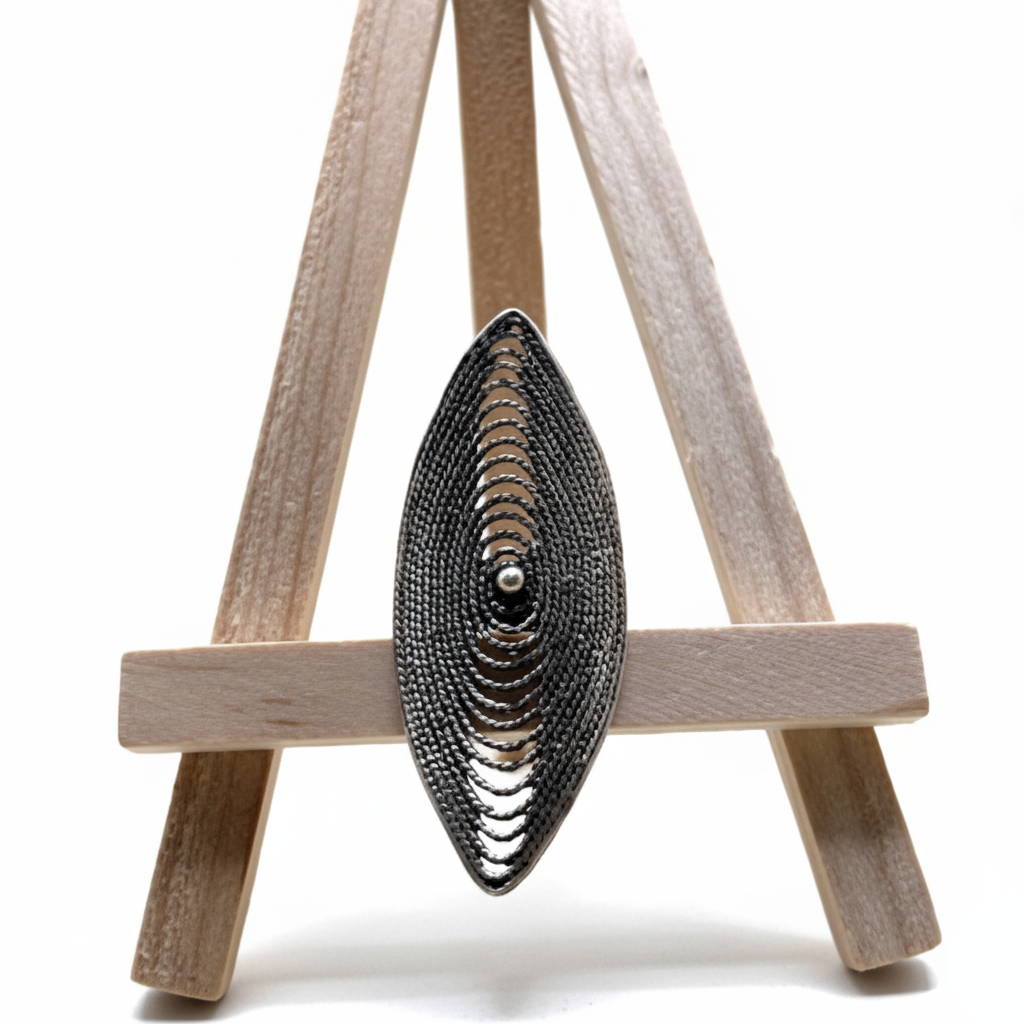 Decorative wall art piece on a wooden easel against a white background