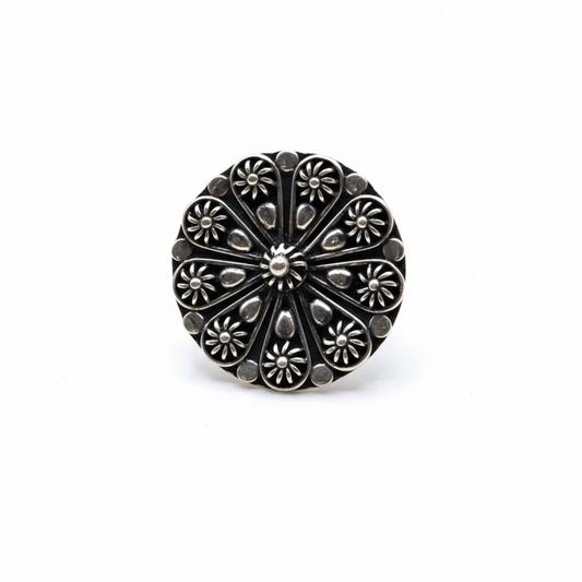 Silver floral-patterned ring on a white background