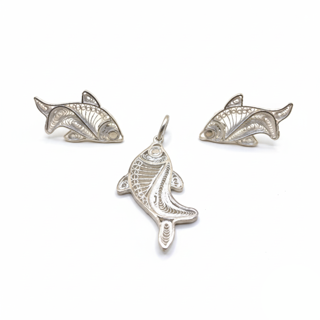 Three silver fish-shaped pendants on a white background