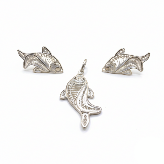Three silver fish-shaped pendants on a white background