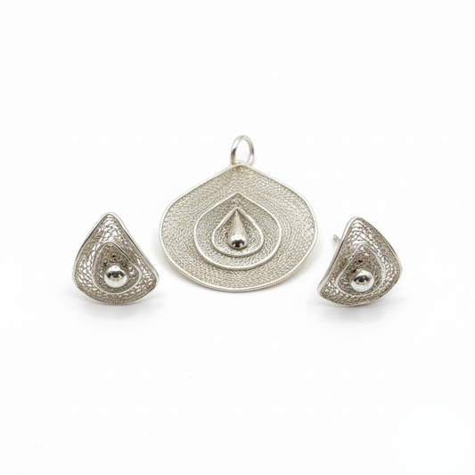 Silver jewelry set with pendant and earrings on a white background