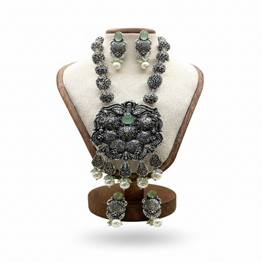 Jewelry set on a wooden stand with a white background