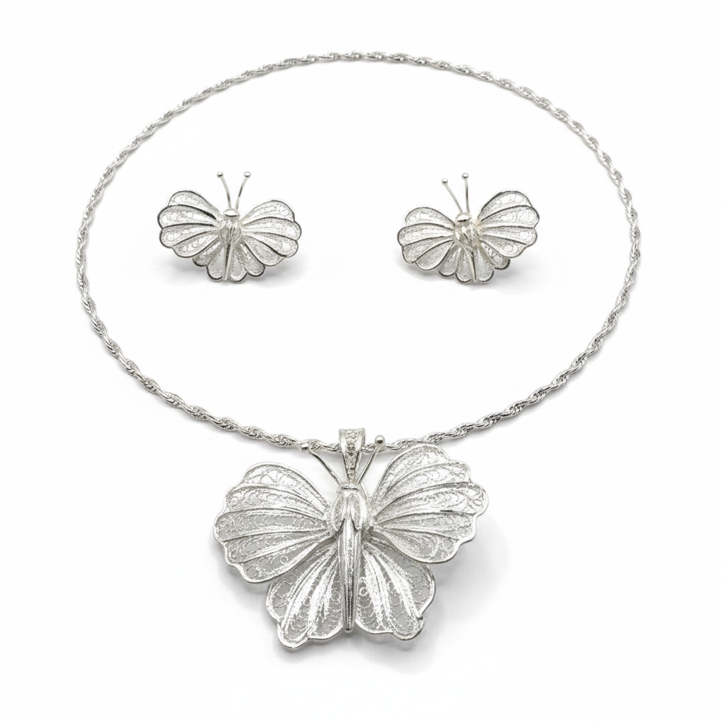 Butterfly necklace and earrings set on a white background