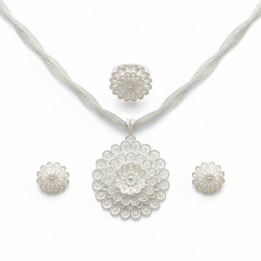 Silver necklace and earrings set on a white background