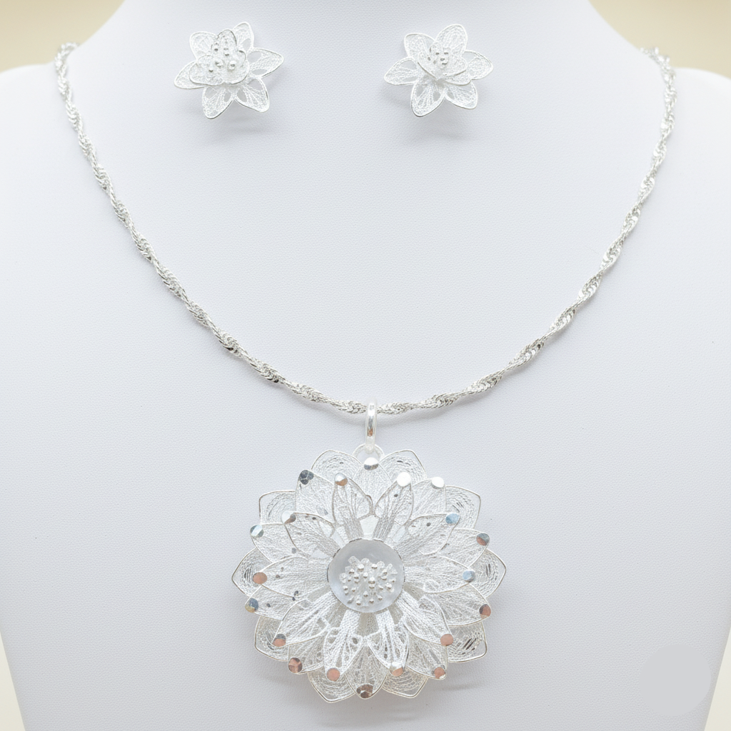 Silver necklace with a detailed pendant on a mannequin against a white background