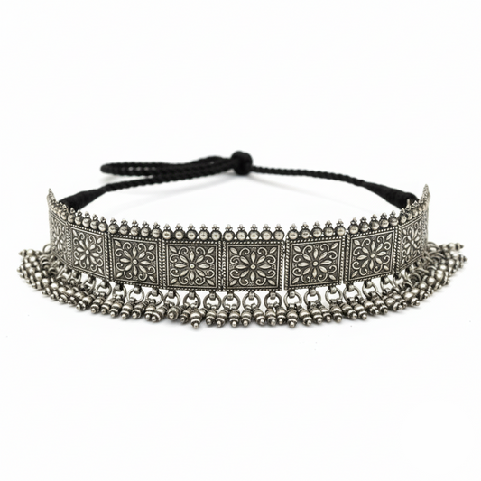 Decorative headband with intricate metalwork and beads on a white background