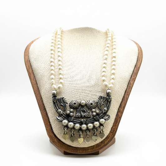 Necklace with decorative elements on a wooden and fabric display